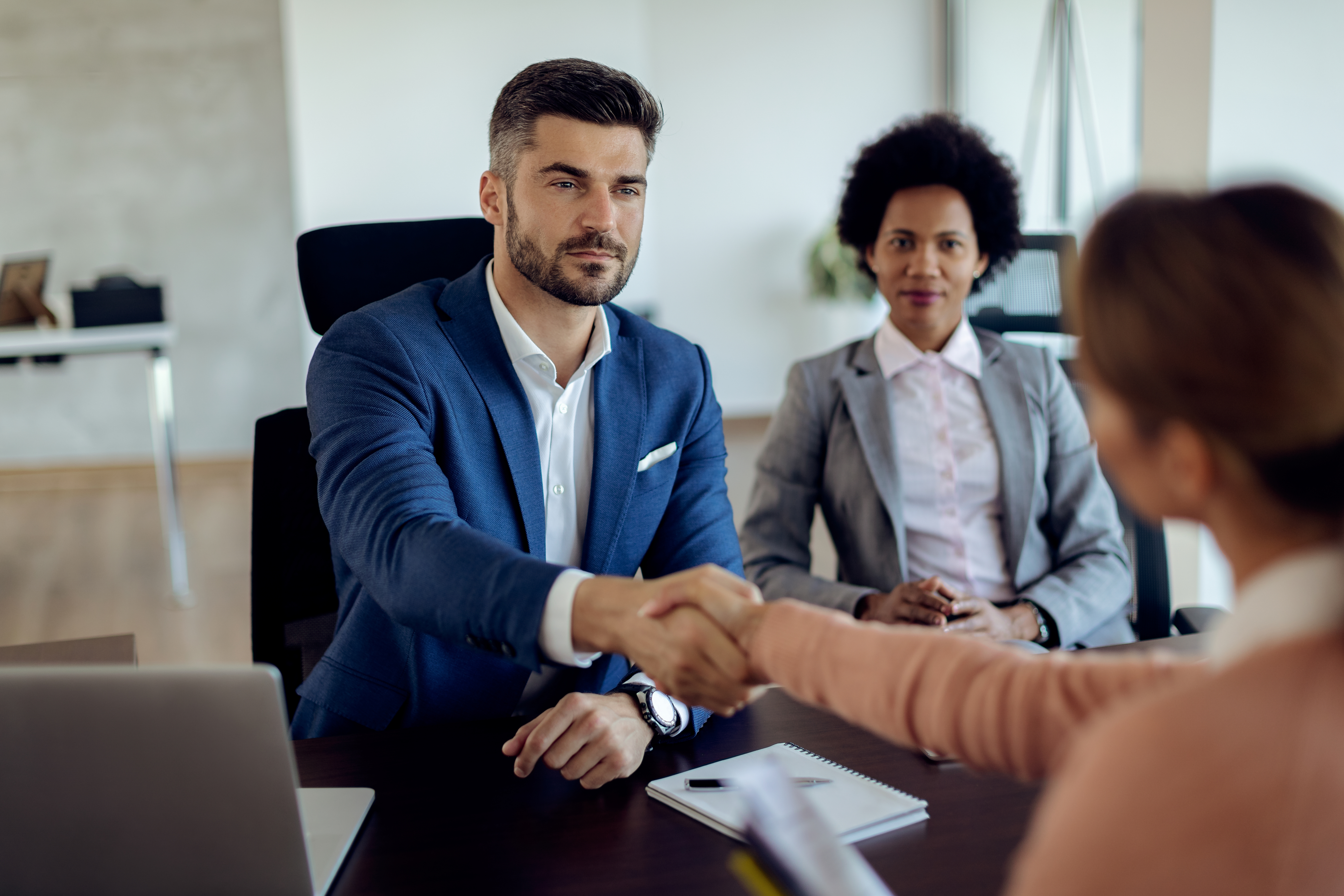 Partner shaking hands with a qualified nursing candidate