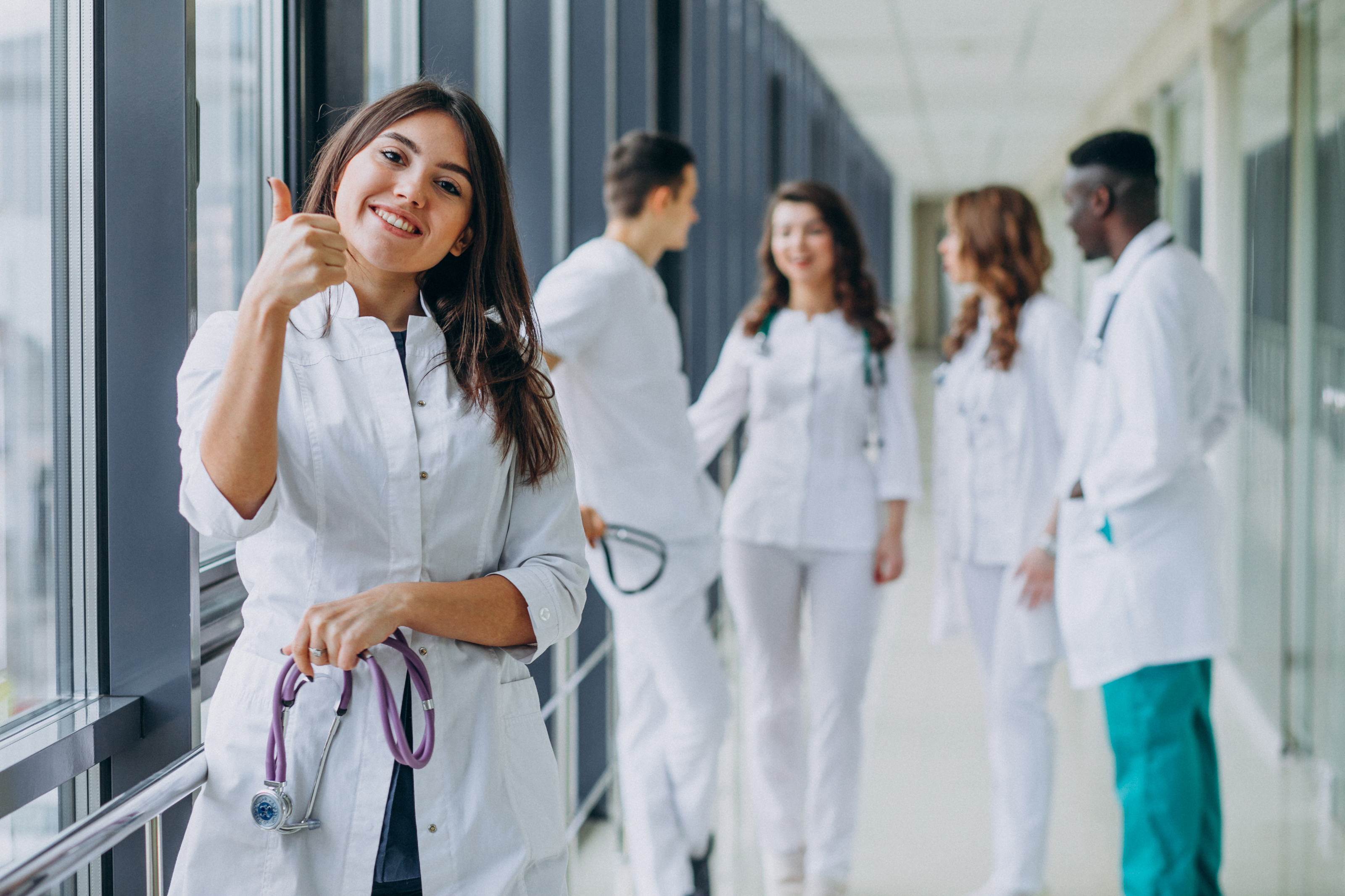 Smiling nurse giving a thumbs up in a modern hospital